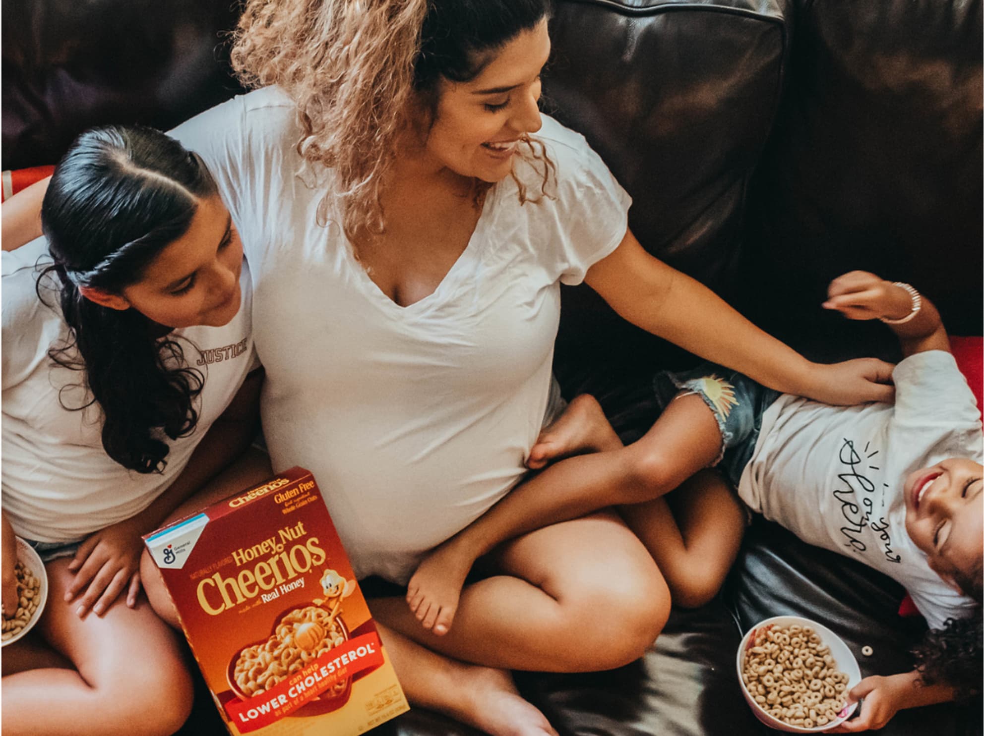A mom and her kids enjoying Cheerios